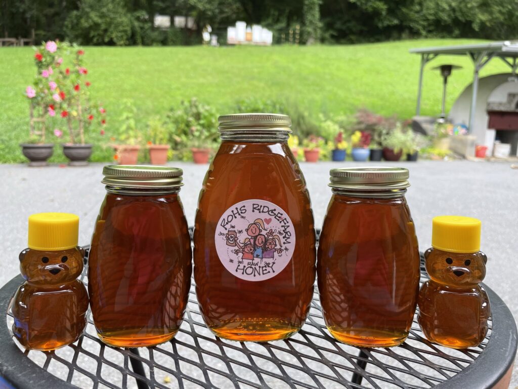 A jar of Rohs Ridge Farm raw honey and honey bears